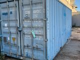 a blue shipping container sitting in front of a building
