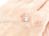 a person ' s hand with a diamond ring on it