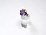 silver ring with multi colored stones on top of a white surface