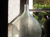 a large glass vase sitting on a window sill
