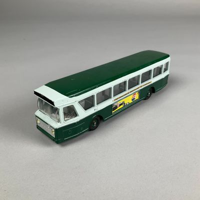 a green and white bus that is on a table
