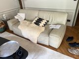 a couch that has a pillow on it in a living room