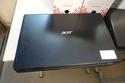 two laptop computers sitting on top of a table next to each other