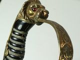 a close up of a sword with a lion head on it