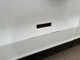 a close up of a white car with a clock on it
