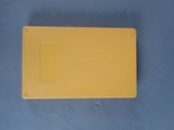 a yellow piece of plastic on a blue surface