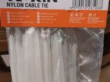white nylon cable ties in a plastic bag on a shelf