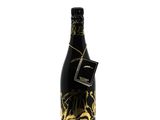 a bottle of black and gold wine on a white background