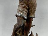 a statue of a boy with a dog on a pedestal