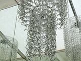 a chandelier hanging from the ceiling in a bathroom