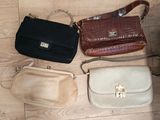 several purses are lined up on a wooden floor next to each other