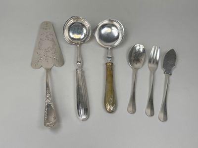 five silver spoons and two silver spoons on a table