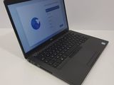 the laptop is sitting on the table with the screen open