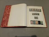 an open book with stamps on it sitting on a table