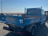 a blue truck that is parked in a lot