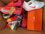 many pairs of shoes in a box with a price tag