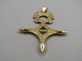 a close up of a cross on a table with a silver background