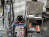 a machine that is sitting in a garage next to a chair