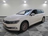 a white volkswagen passat is parked on a checkered floor