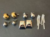 de nombreux bijoux en argent et en or posés sur un fond noir