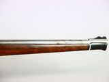 a close up of a rifle with a wooden handle