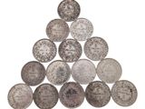 a pile of silver coins stacked on top of each other
