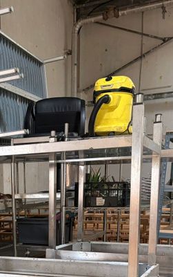 a luggage cart in the middle of a warehouse filled with luggage