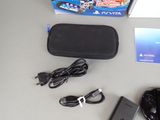 a box with a game controller and a charger next to it