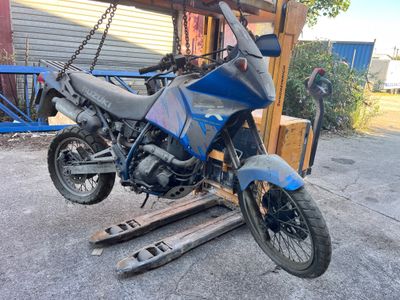 a blue motorcycle that is parked on a pallet