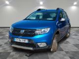 the front end of a blue dacia parked on a checkered floor