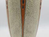 a close up of a vase with a dragonfly design on it