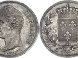 a close up of a coin with a crown on top of it