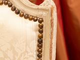 a close up of a white chair with a gold trim