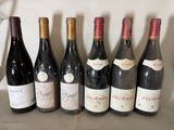 several bottles of wine are lined up on a shelf