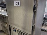 a stainless steel refrigerator in a kitchen with a price tag on it