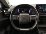 the interior of a car with a steering wheel and dashboard controls