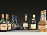 several bottles of liquor are lined up on a table