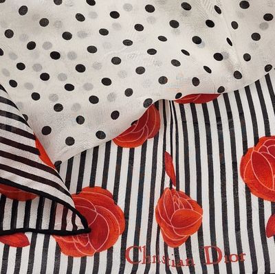une écharpe rayée en noir et blanc, ornée de roses rouges