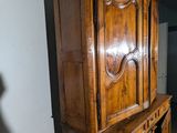 a large wooden cabinet in the corner of a room