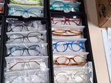 a drawer full of glasses and a pair of shoes
