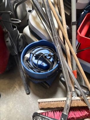 a pile of tools sitting on the floor of a garage