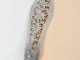 a metal object that is hanging on the wall