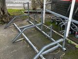 a metal bench that has been placed on the side of the road