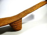 a wooden bench with a long wooden handle on it