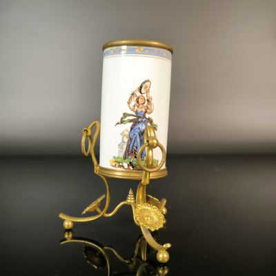 an image of a candle holder with a picture of a woman on it