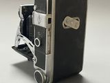 a black and silver camera sitting on a white surface
