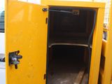 a small yellow cabinet in the back of a white truck