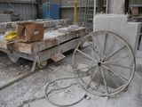 a wagon with a wheel on the side of the road