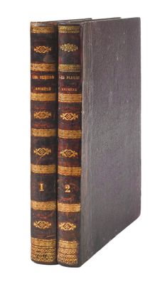 a pair of books sitting on top of each other on a white surface