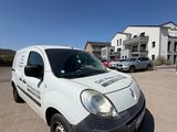 the white van is parked in the parking lot outside of the building